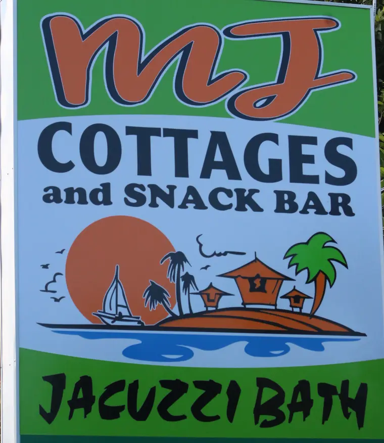 Original roadside sign of MJ Cottages and Snack Bar